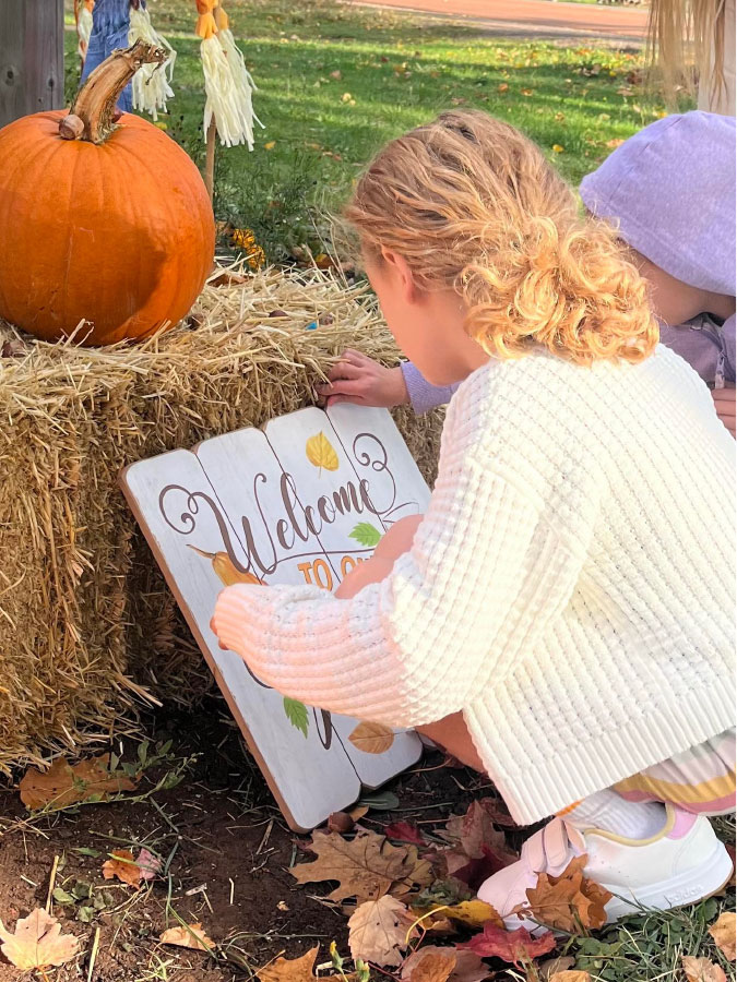 kids next to pumkin